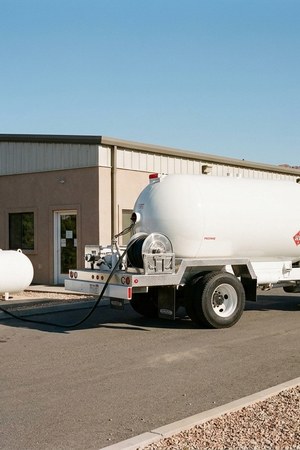 A Running Horse Services propane bobtail making a commercial pad delivery.