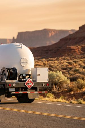 A Running Horse Services propane bobtail on a high-desert road.